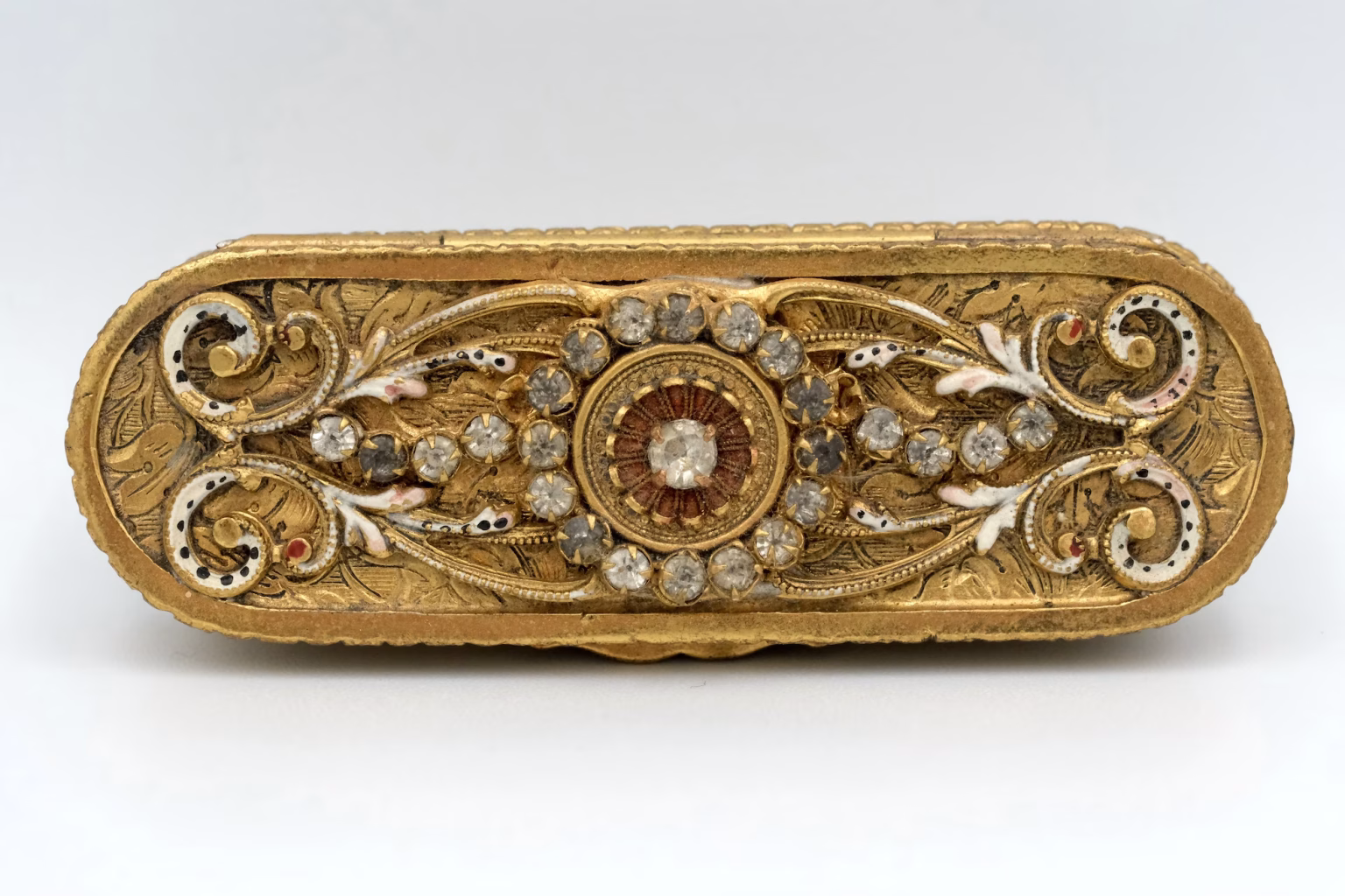 top of a 19th century trinket box, with gold and silver colored filigree