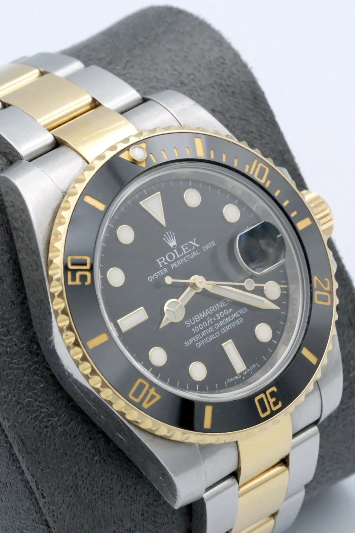 a rolex submariner with a black dial & silver movement on a watch display
